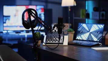 Panning shot of podcast microphone used to record discussions for internet livestreaming channel and 3D renders running on notebook screen. High tech streaming sound capturing and recording devices photo