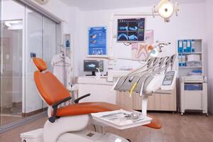 Interior of empty oral stomatology orthodontist office with dental teeth radiography on monitor. Professional dentistry hospital room with nobody in it prepared for tooth diagnosis treatment photo