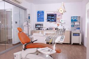 Empty modern orthodontic stomatology hospital light office with nobody in it equipped with dental intruments ready for teeth healthcare treatment. Tooth radiography images on display photo