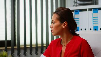 Portrait of hispanic lady using computer in modern office. Entrepreneur working in professional workspace, workplace in personal corporate company typing on pc keyboard looking at desktop photo