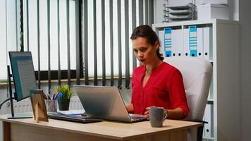 Woman using laptop and pc in same time in office room. Entrepreneur working in modern professional workspace, workplace in personal corporate company typing on computer keyboard looking at desktop photo