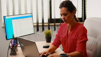 Woman having video conference on laptop in workplace early in the morning. Freelancer working with business remotely team discussing chatting having online meeting, webinar with internet technology photo