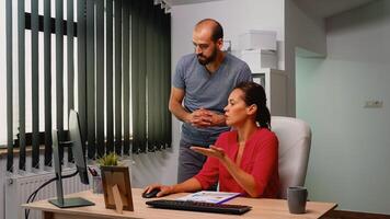 Businesspeople crew working with new startup project in modern loft. Team talking consulting in professional workplace, in personal corporate company typing on computer keyboard looking at desktop photo