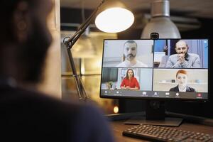 Manager discussing financial graph with remote colleagues during online videocall meeting conference, working overtime at company strategy in startup office. Business management concept photo