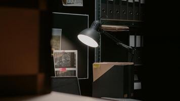 Empty incident room filled with clues and case files, evidence map with photos and suspects background checks. Police archive space used to conduct criminal investigation, forensic science.