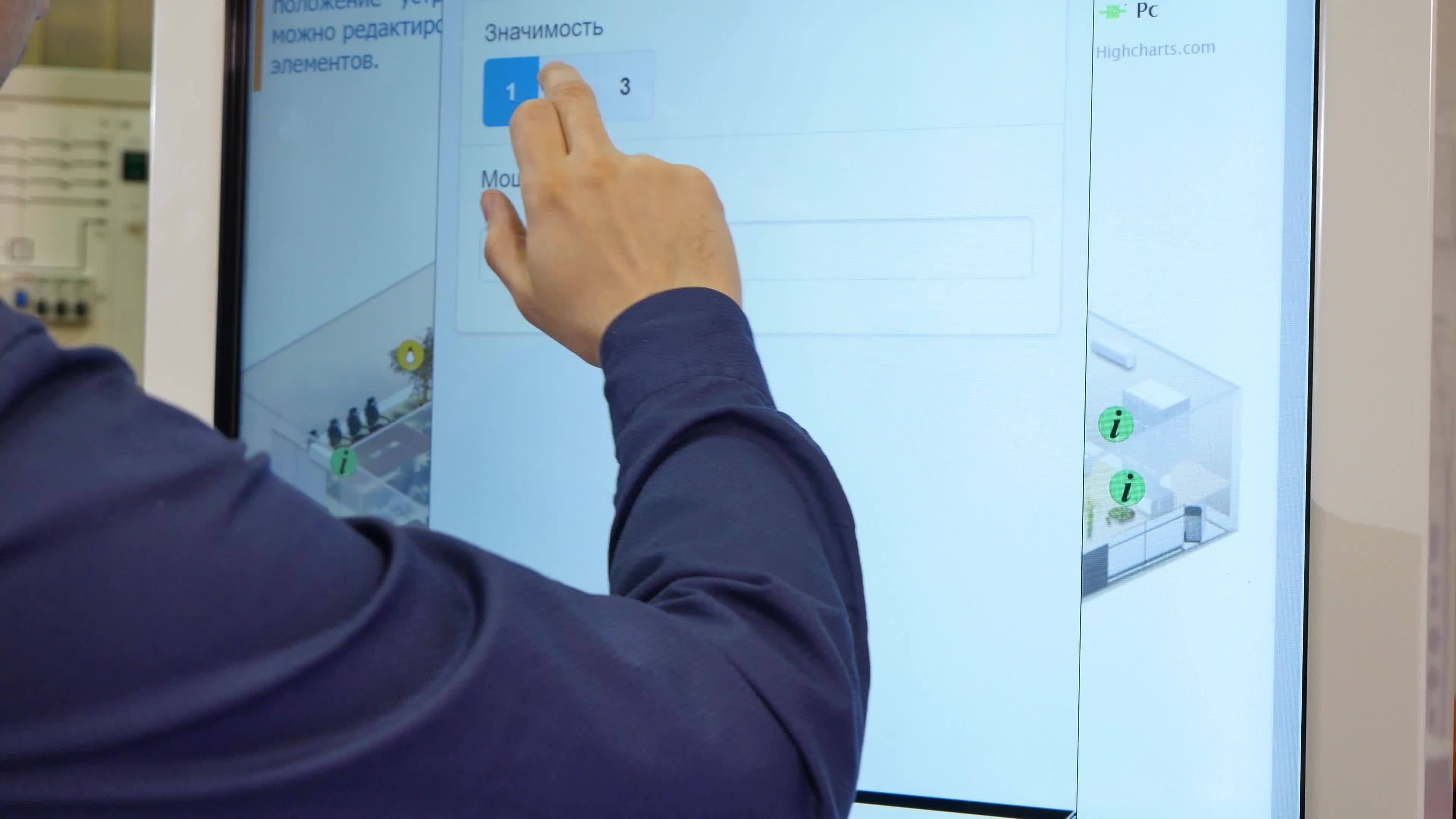 Man works on a touch screen. Young scientist uses a large touch screen ...