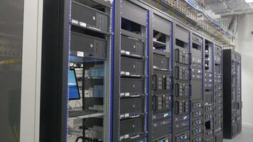 Many powerful servers running in the data center server room. Many servers in a data center. Many racks with servers located in the server room. Bright display a plurality of operating equipment. video