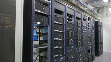 Many powerful servers running in the data center server room. Many servers in a data center. Many racks with servers located in the server room. Bright display a plurality of operating equipment. video