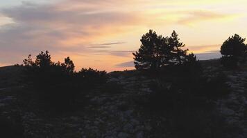 Top view of rocky top on background of sunset colors with clouds. Shot. Colorful picturesque landscape of sunset sky with clouds video