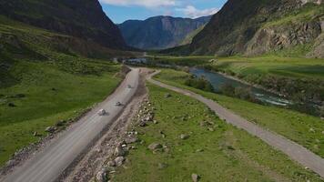 Road and car against the backdrop of a mountain landscape in summer video