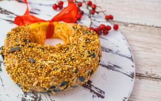 Treats for wild birds in winter. Homemade pumpkin feed, bacon, millet, seed on a white wooden background. View from above. photo