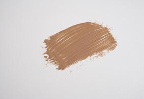 close-up smear of foundation, red clay masks on a white background photo