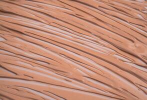 Makeup base cream blur, red clay mask texture. Background photo