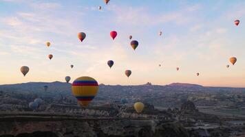 Hot air balloon flight in Goreme in Turkey during sunrise. Ride in a hot air balloon, the most popular activity in Cappadocia. Romantic and famous travel destination. video