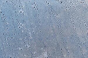Background of the condensate drops on the film is polyethylene. Water drops texture photo