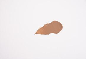 close-up smear of foundation, red clay masks on a white background photo