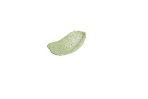 A sample of a natural green scrub on a white background. Peeling cream with microcapsules. Smear of apple or coffee scrub photo