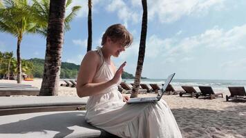 digital nómada, mujer trabajando en tropical playa video