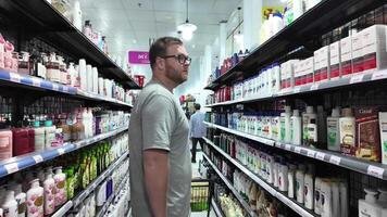 Man Browsing Hair Care Products Aisle Pho Quoc, Vietnam,  15 January 2024 video