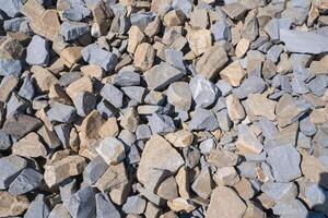 Gravel texture. Pebble stone background. Light grey closeup small rocks. Top view of ground gravel road photo