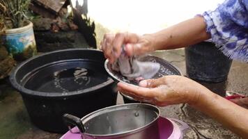 someone washing a pan with foaming soap, close up view, 4k resolution video