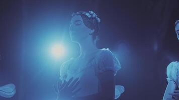 ballerina stand on stage in a frozen pose during a ballet performance. video