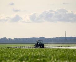 Tractor with a spray device for finely dispersed fertilizer. photo