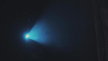 Scene illumination with a profiled blue beam of a profile spotlight in the smoke from a smoke machine from top to bottom video