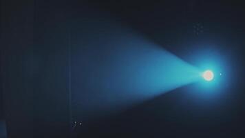 The blue light from the spotlights through the smoke in the theatre during the performance. Lighting equipment. video