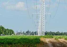 Transmission tower on a background field of soybeans photo