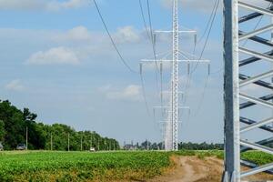 Transmission tower on a background field of soybeans photo