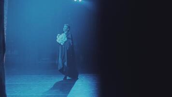 the soloist, ballet dancer, dances during the performance with a bouquet of flowers. video