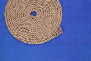 Ship rope on blue background, top view photo
