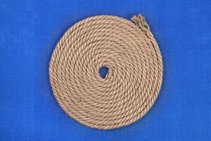 Ship rope on blue background, top view photo