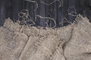 Black wooden table with burlap tablecloth photo