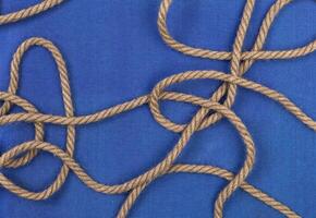 Ship rope on blue background, top view with copy space photo