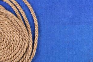 Ship rope on blue background, top view with copy space photo