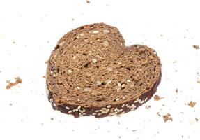 Sliced bread in the shape of heart on white background photo