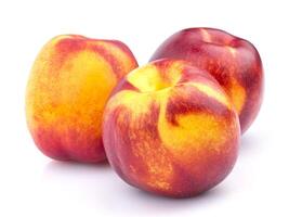 Whole nectarine fruit isolated on white background photo