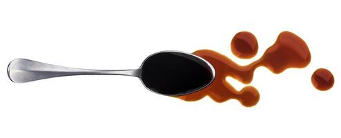 Soy sauce. Splashes and spilled soy sauce with spoon isolated on white background. Top view photo
