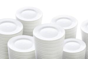 Stack of white plates isolated on white background photo