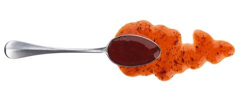 Cranberry sauce with spoon isolated on white background. Top view photo