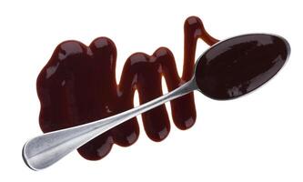 Barbecue sauce. Splashes and spilled grill sauce with spoon isolated on white background. Top view photo