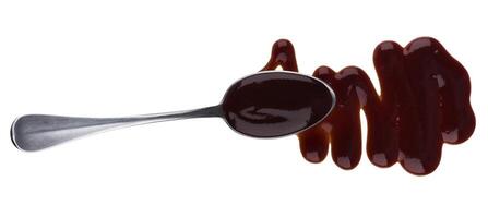 Barbecue sauce with spoon isolated on white background. Top view photo