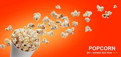 Popcorn in cardboard box, isolated on red background photo