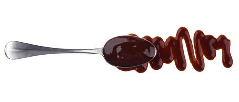 Barbecue sauce. Splashes and spilled grill sauce with spoon isolated on white background. Top view photo