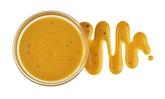 Mustard sauce in bowl isolated on white background. Top view photo