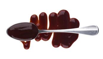 Barbecue sauce with spoon isolated on white background. Top view photo