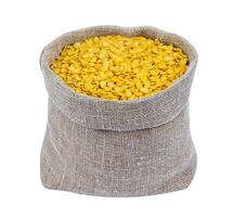 Yellow lentils in bag isolated on white background photo