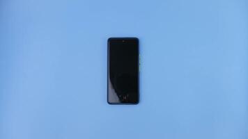 Mobile phone isolated on blue background. photo